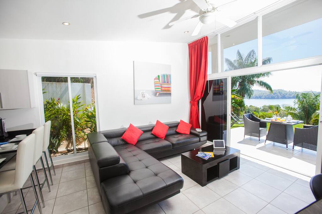 Modern living space with garden view to the ocean beyond!