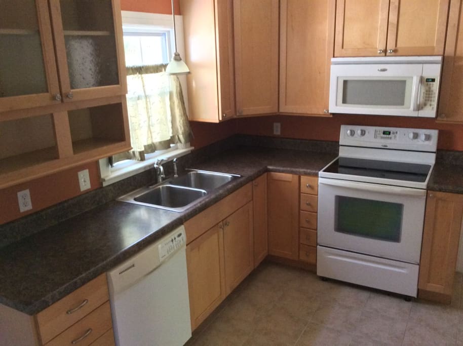 Kitchen with stove, microwave, refrigerator, dishwasher