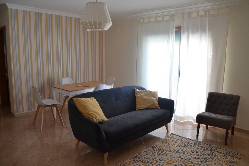 Spacious living room with TV and a table for 4