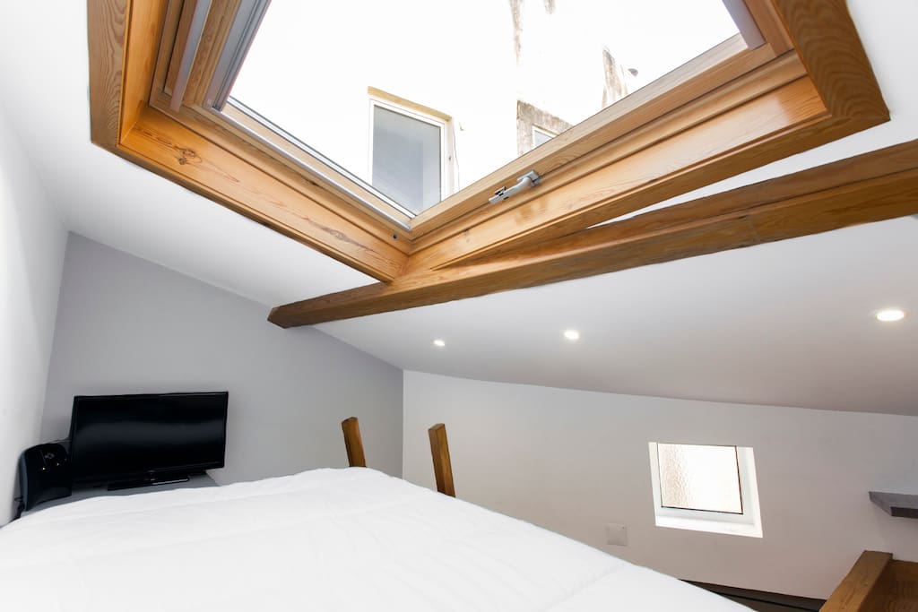 Bright mezzanine with oversized window and TV.