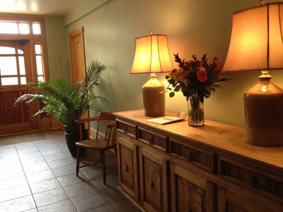 The entry foyer with credenza & double sided fireplace.