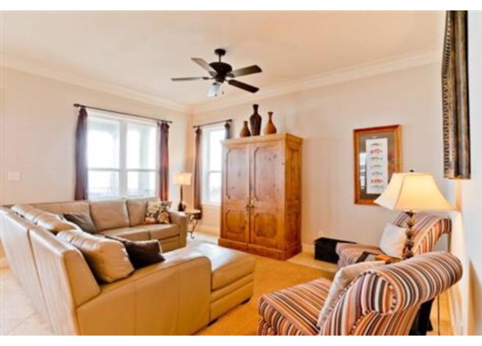 The main living area off the kitchen has a huge leather sectional for plenty of seating.