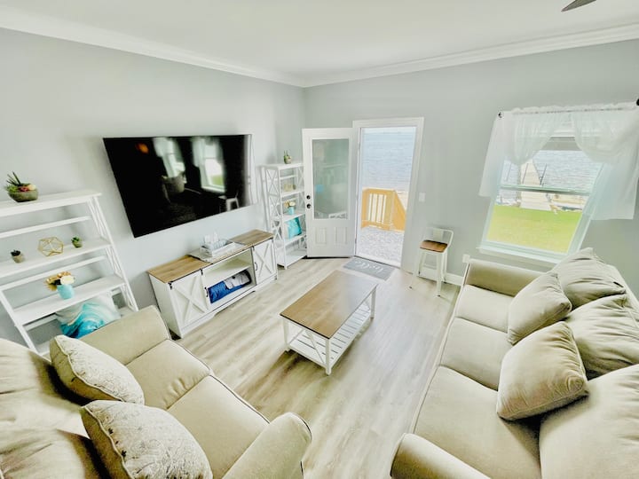 Birds eye view of living room showing way to the back yard and water 