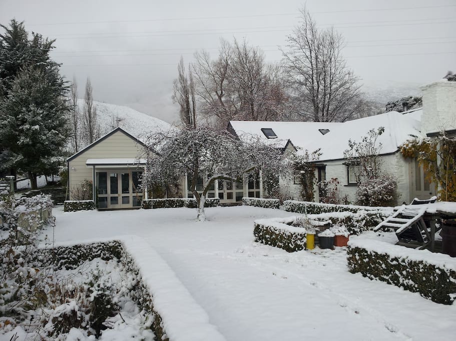 Old cottage and guest wing under snow