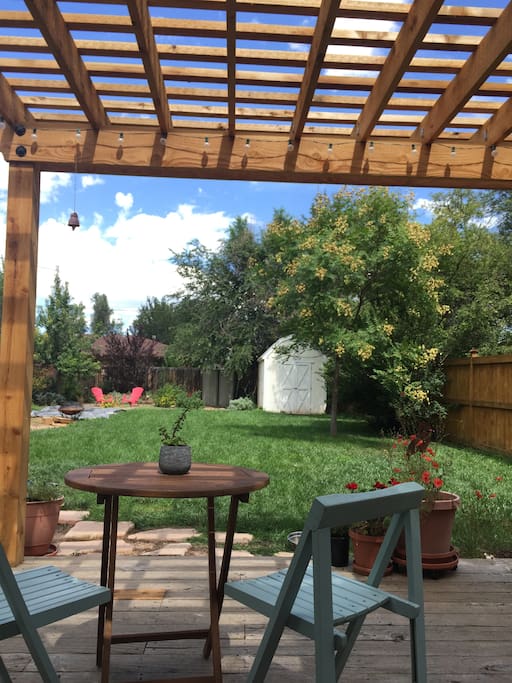 Cedar pergola over redwood deck. Outdoor lights and a gas grill make for cozy evenings in the backyard.