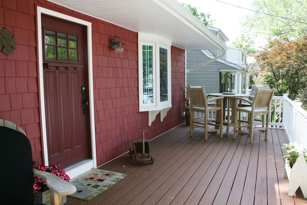 Spacious front porch with 2 adirondack chairs and seating for 4.