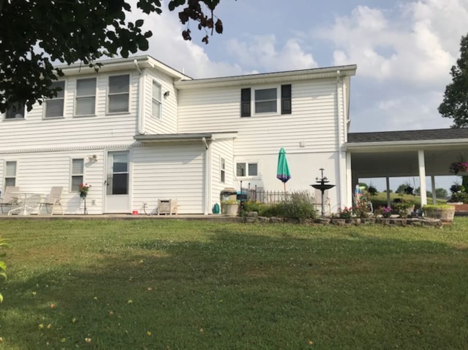 Back of house showing apartment entrances from back and from carport