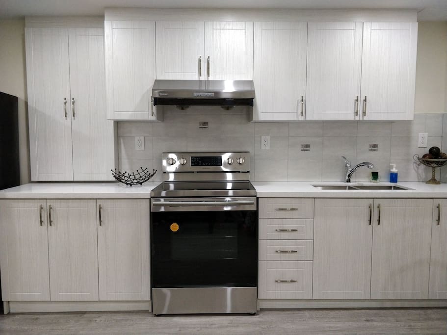 A gorgeous kitchen that consists of a stove and a fridge