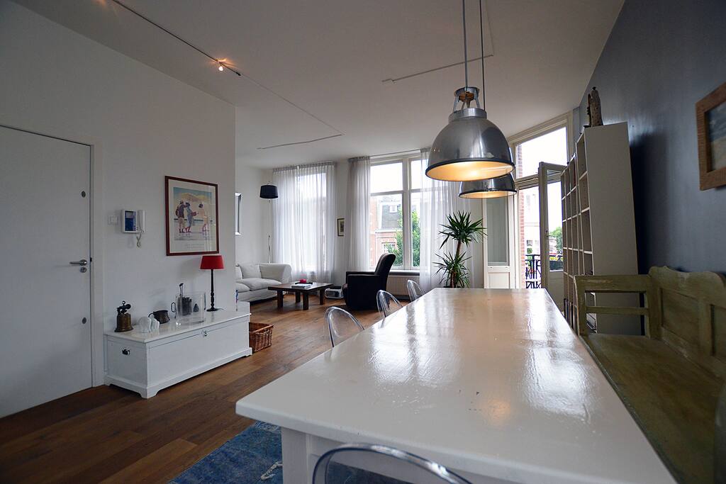 The large dinner table with the living area in the back