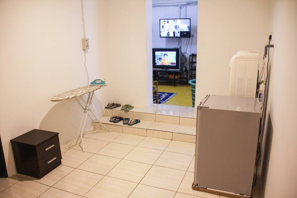 Ironing board, fridge and water for guests.
