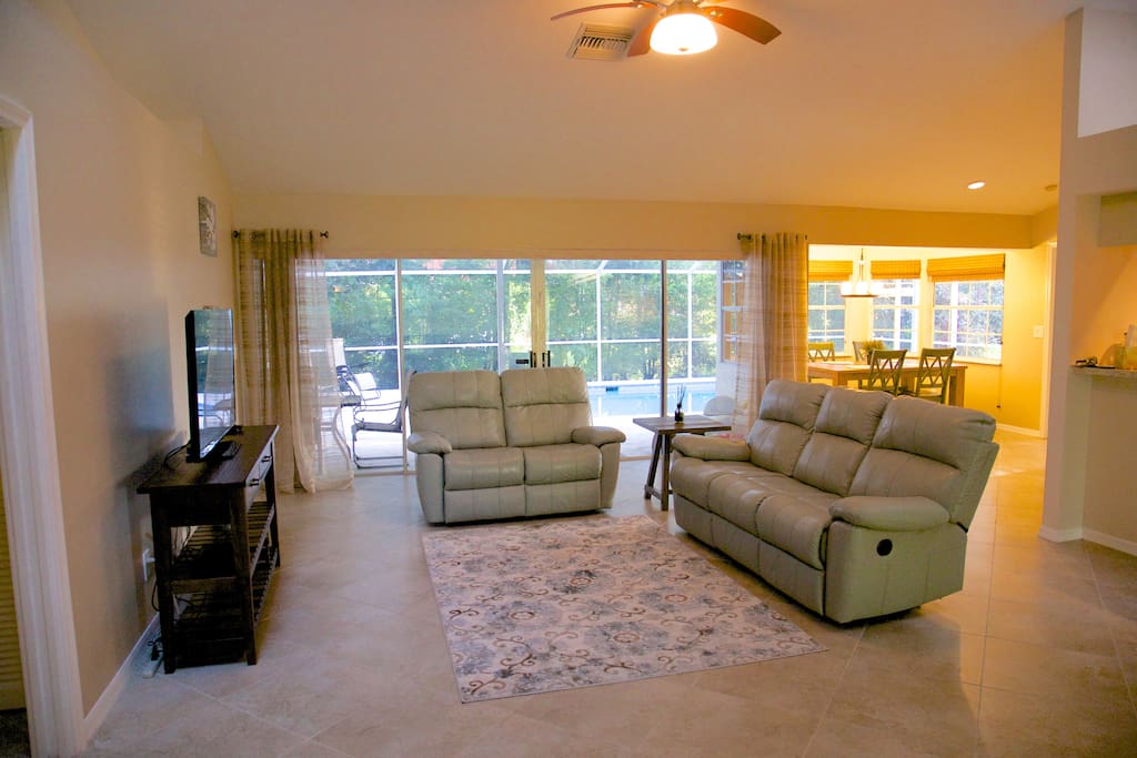 Large open living room with reclining sofa and loveseat