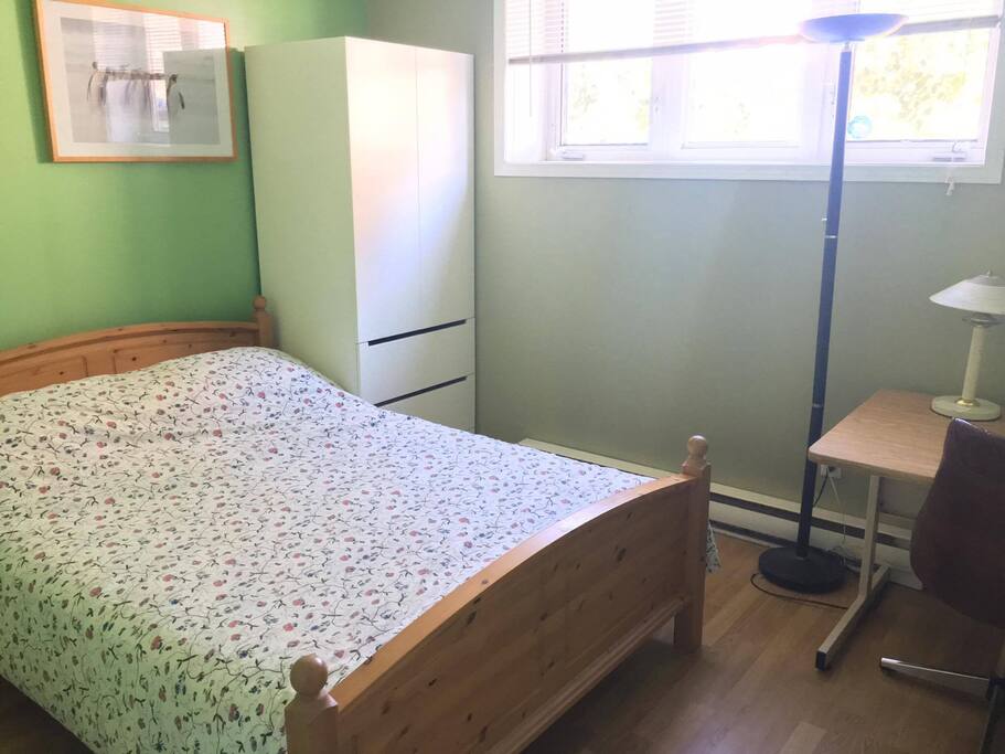 The first bedroom, which is slightly smaller than the other but still lots of windows for natural light.
