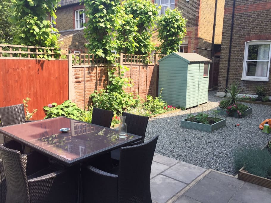 Private garden with outdoor table and BBQ