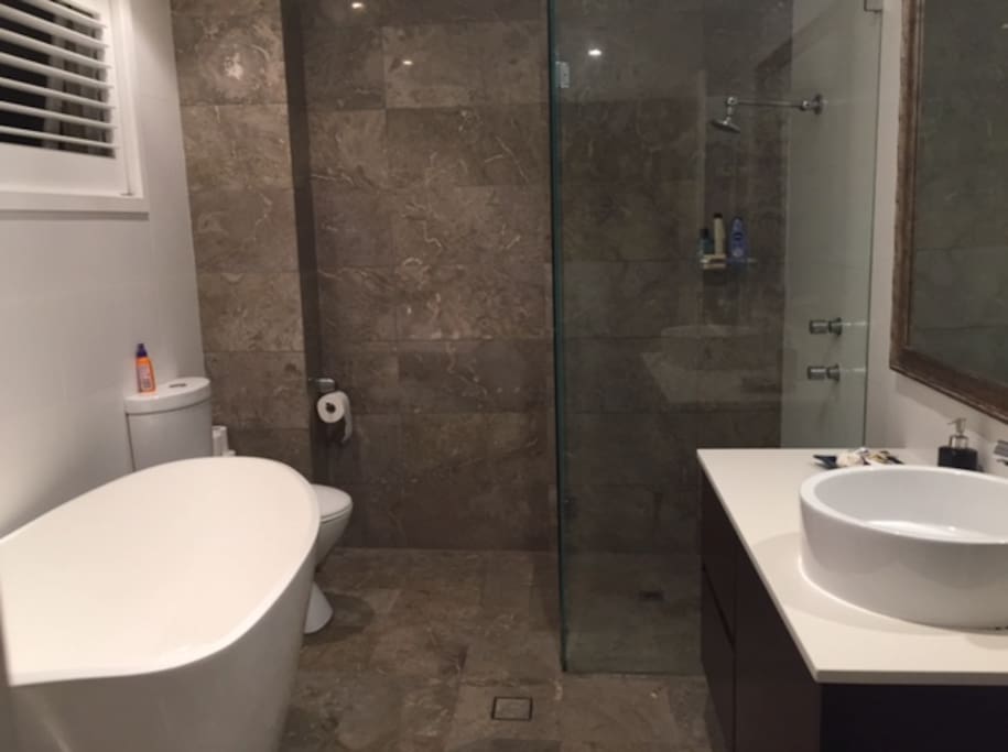 Guest bathroom with bath, shower and toilet