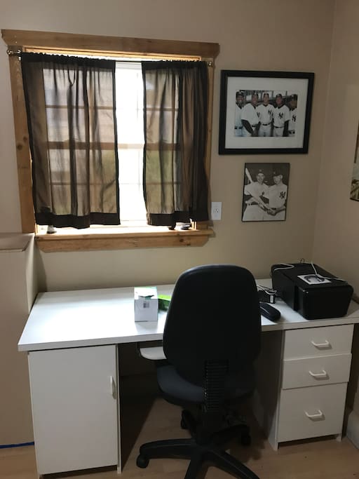 Large professional desk with printer and window/curtains. Comfortable desk recliner chair swivels. Wifi