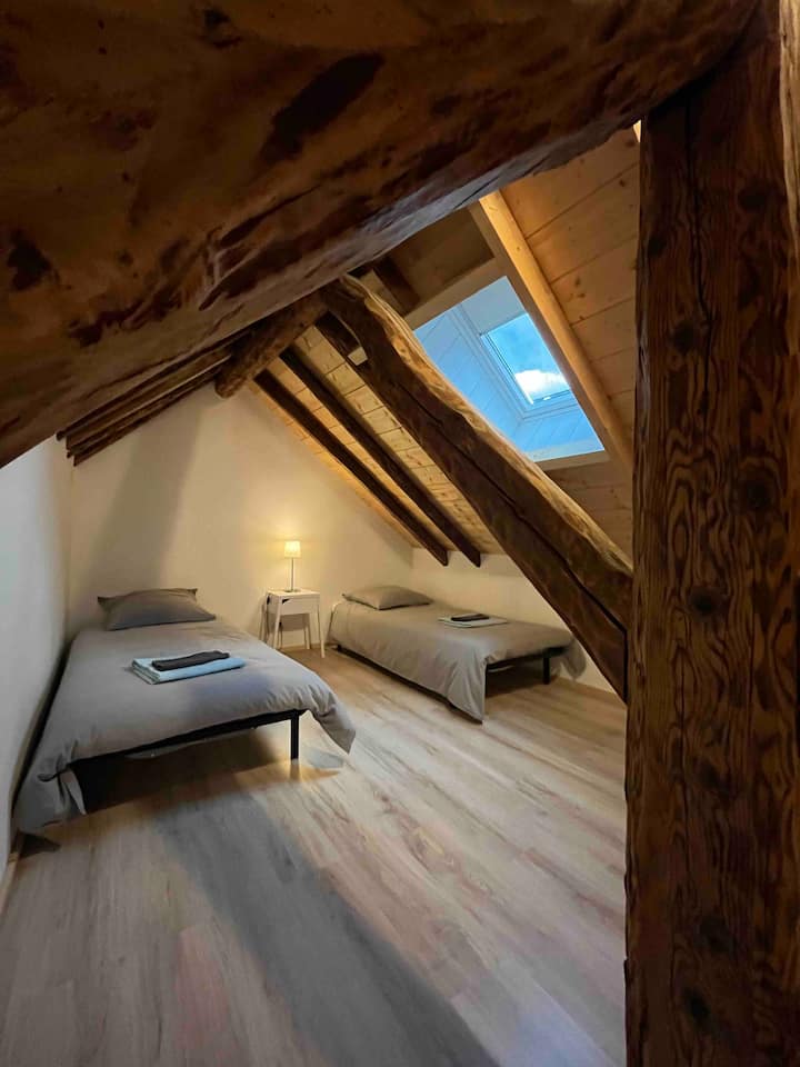 Bedroom with three single beds under the rooftops