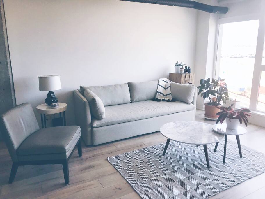 The bright and airy living space is perfect for lounging, reading, and simply enjoying the stunning scenery outside.