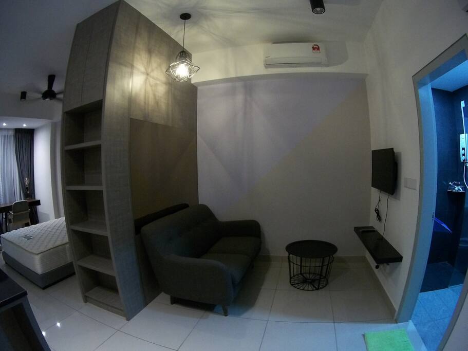 Cosy living room, with Scandinavian 2-seater sofa and a 32' TV.