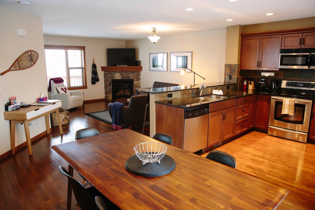 Living/Kitchen open plan space. The Dining area has seating for 6, and the kitchen counter seats 3.
