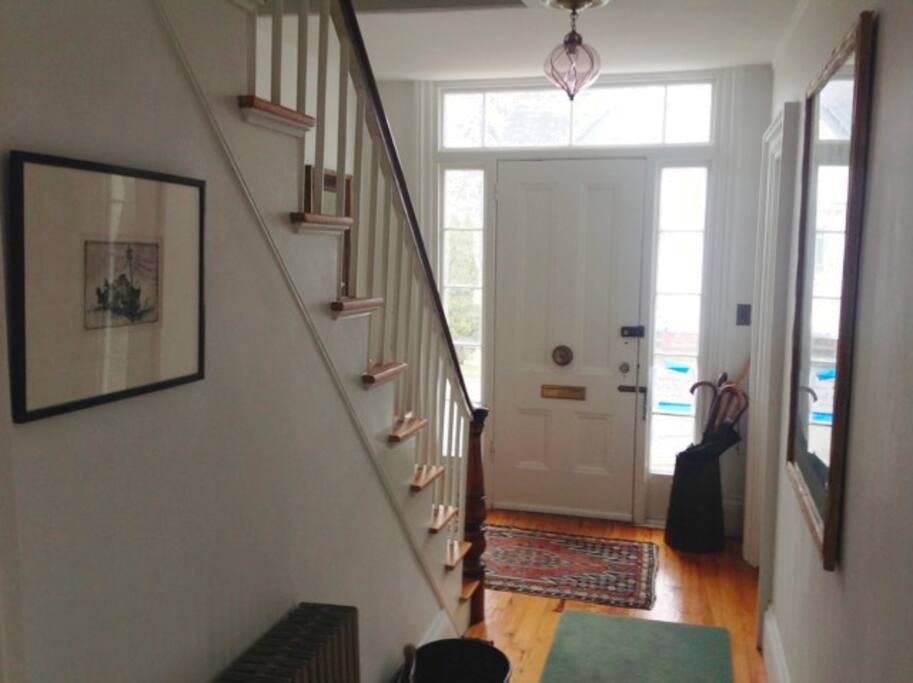 Front stair case and front entrance. We recommend using the side porch entrance where there is a space for coats and boots.