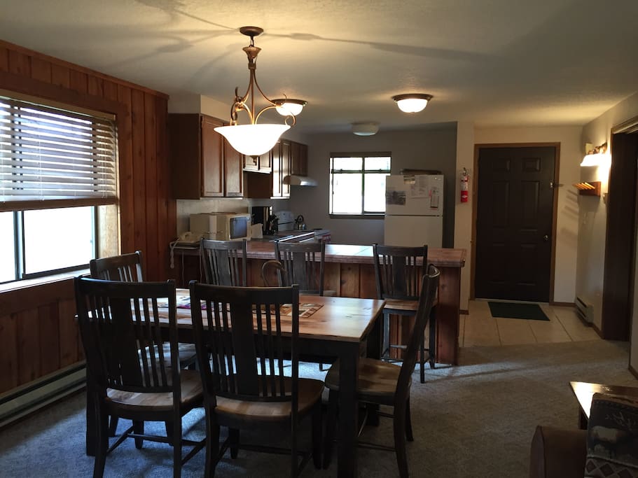 Dining area and kitchen of unit. Seating for 6 at the dinner table.