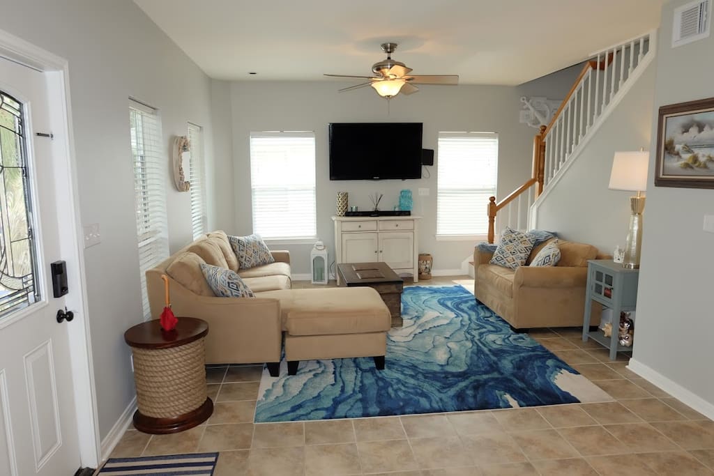 Open living area with TV and sound bar. Love seat pulls out to twin bed.