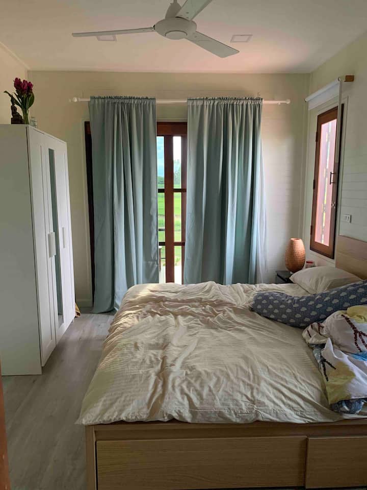 Your bedroom, should you decide to stay with us. Sometimes we even make the bed ;)
Your view is directly onto our rice fields, and you have access straight to the balcony. 