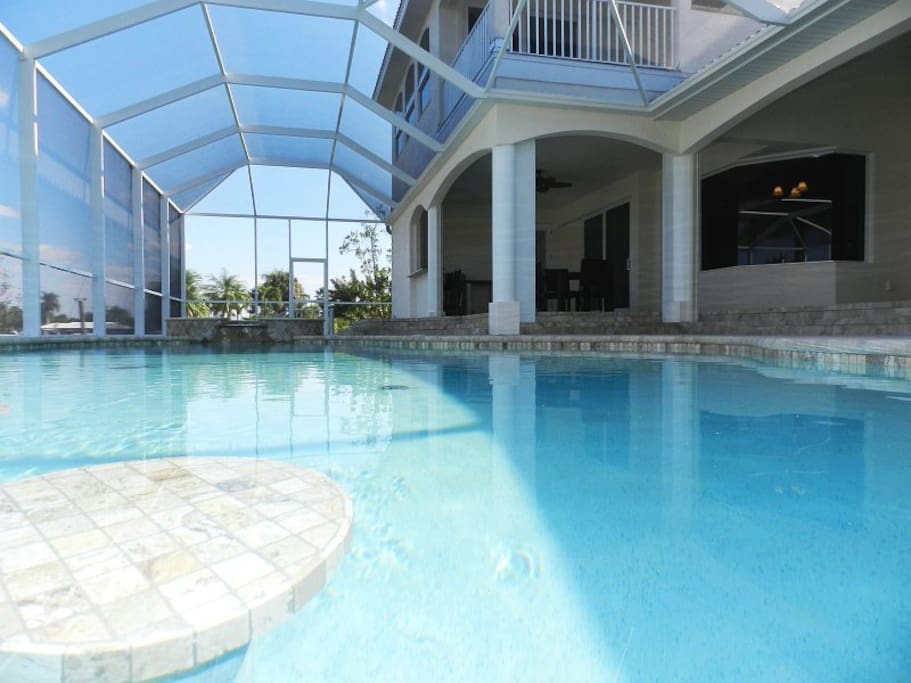 Electric Heated Pool and Spa with Waterfall and Bar and Stools in Pool
