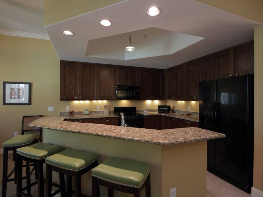 Well stocked gourmet kitchen w/raised panel cabinetry, granite counters, & abundance of storage/working space for your culinary endeavors