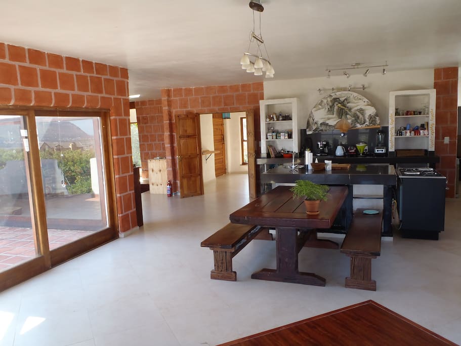 An open plan, well equipped kitchen, dining area and lounge with fireplace