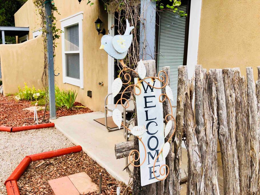 Front entrance to the adobe suite, private patio, and walkway to provided parking.