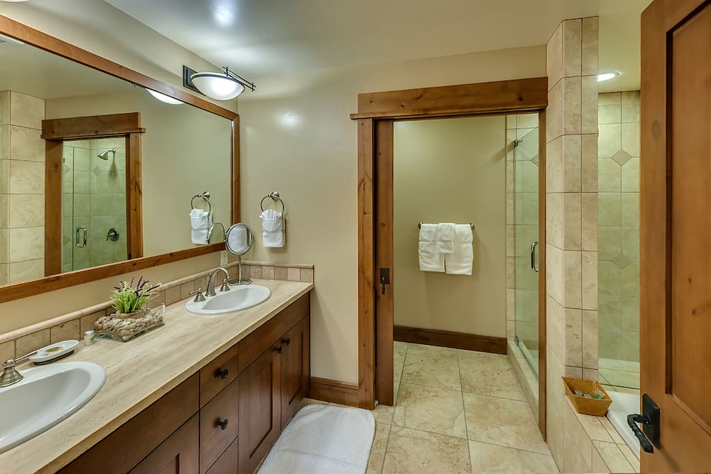 Full bathroom with dual sinks in studio