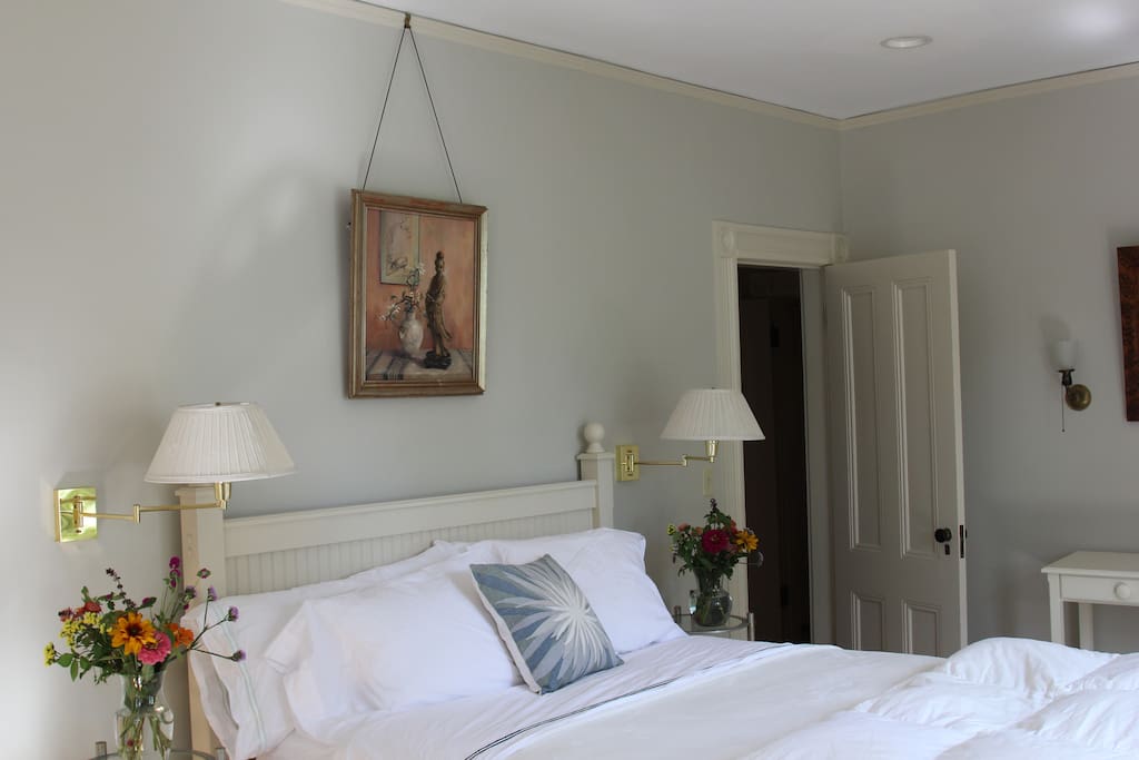 The master bedroom has four large windows with southern and eastern exposure spilling natural light into the room. The comfortable linens, down comforter and queen mattress are new.