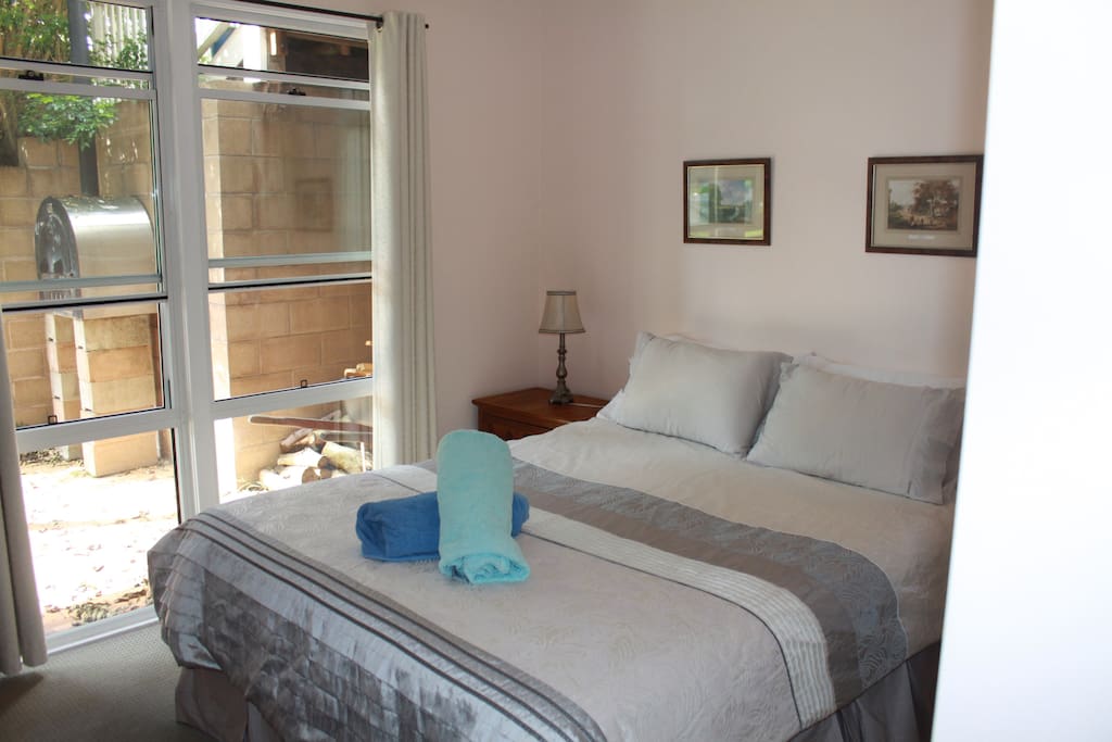 Main bedroom with Queen size bed, ceiling fan and built in wardrobe.