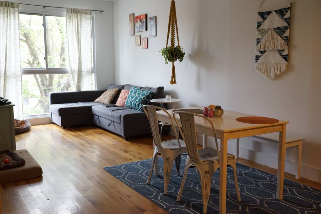 Dining and living area with huge windows that bring in lots of natural light