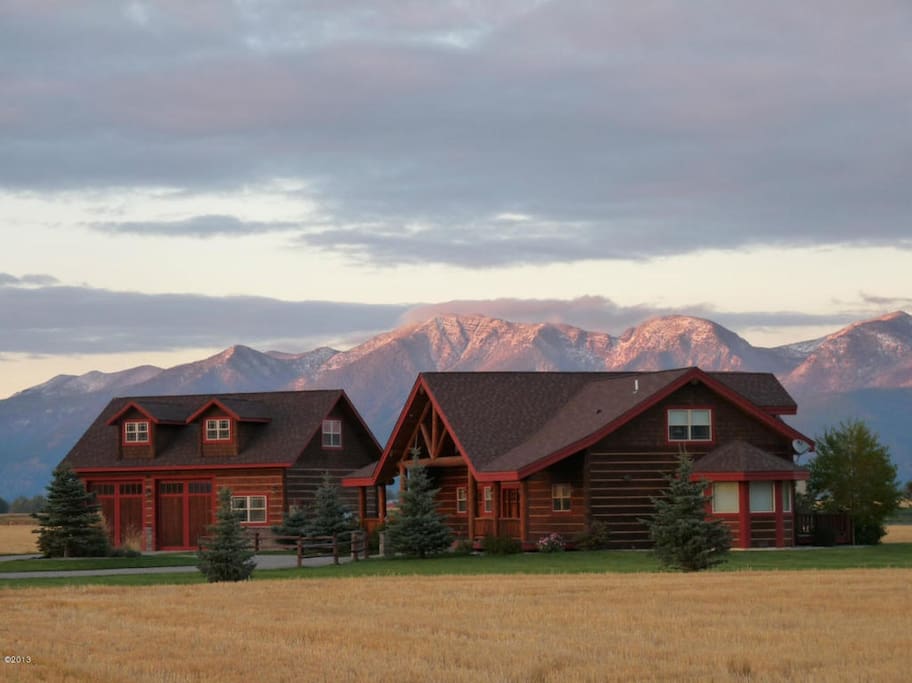 View of Home with Mountain Range Glowing Behind