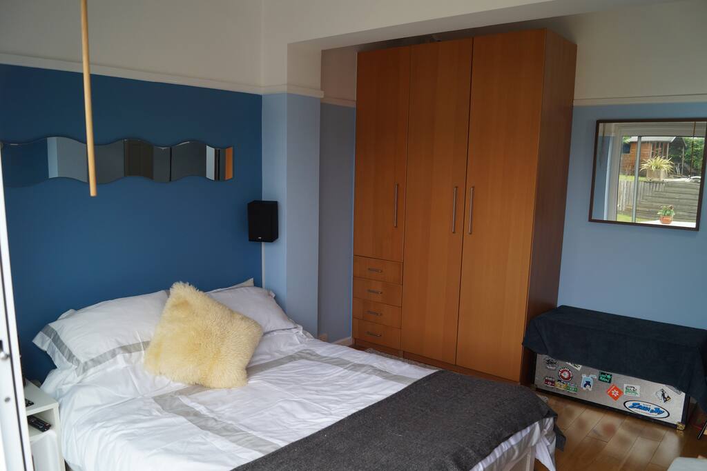 A comfortable King size bed in a spacious large room.