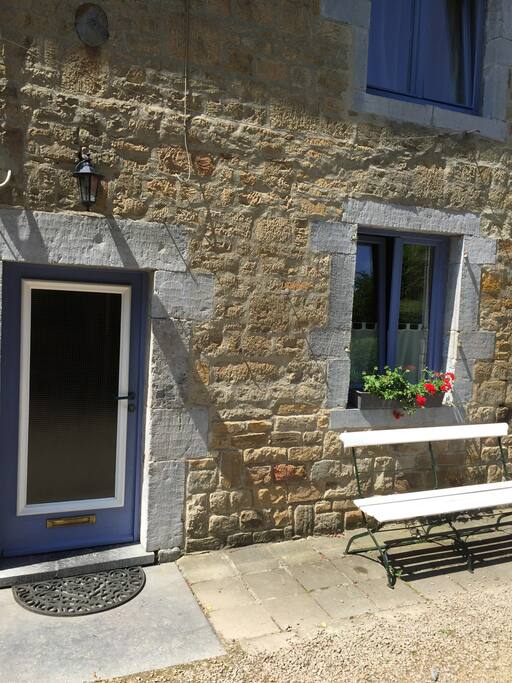 The entrance door and the bench