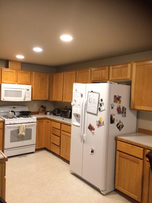 Stocked kitchen with lots of spices, cooking utensils, vitamix, etc