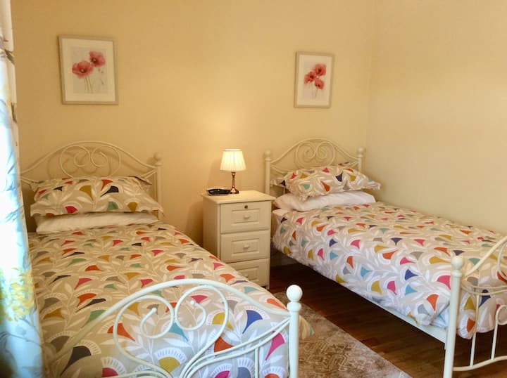 The 2nd bedroom is a twin-room en-suite with comfortable single beds tastefully dressed with hotel quality bed linen.  The en-suite has a walk-in assisted shower area, no steps, locker and bedside light with clock radio and black out window blinds