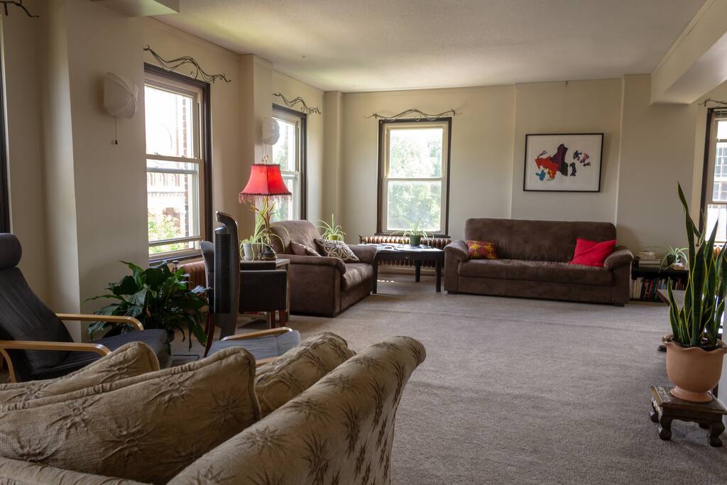 A view of the common living space which features plenty of seating space and natural lighting.