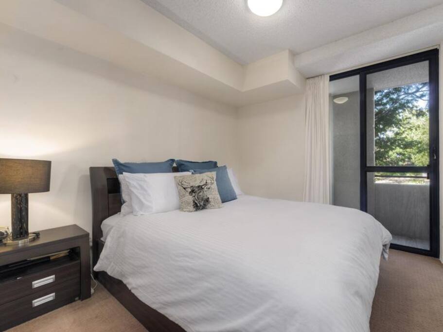 bedroom with access to bathroom and balcony