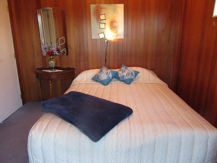 Queensize bed over looking the barbecue area.