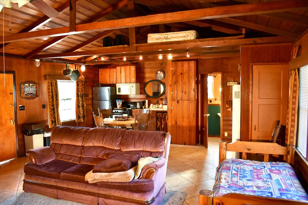 Kitchen, refrigerator, stove, microwave, oven, full bathroom, couch, and available storage.