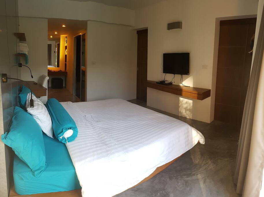 Flat screen TV with DVD player available in bedroom.