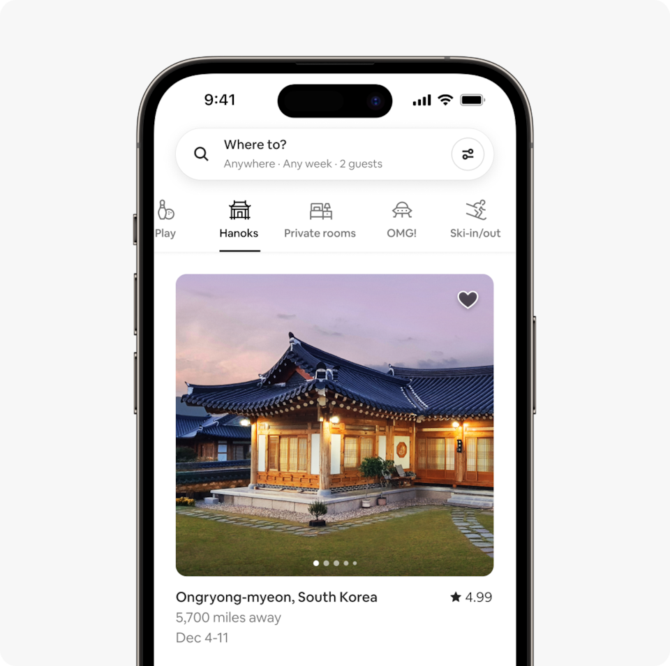 A laptop and a phone show the Airbnb homepage with two rows of homes from a new Airbnb Winter Release category called Hanoks, which features traditional 14th century South Korean homes made of natural materials.