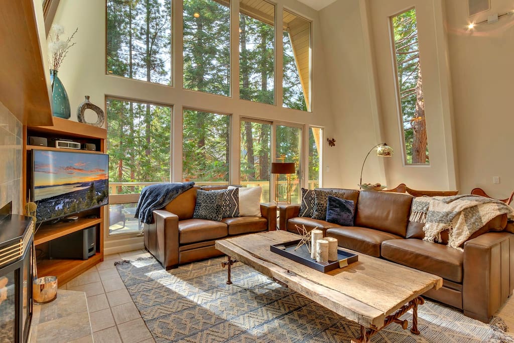 Comfortable seating with ample throw blankets, gas fireplace, and ample entertainment options. 20' floor to ceiling windows let the outdoors in.