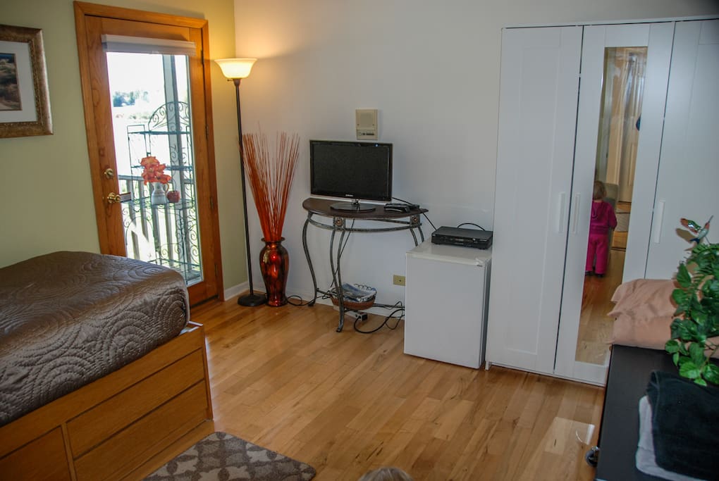 Room includes TV, small refrigerator, and clothes closet. Notice outside door connects to gazebo room.