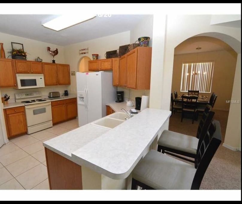Spacious fully stocked kitchen with breakfast bar