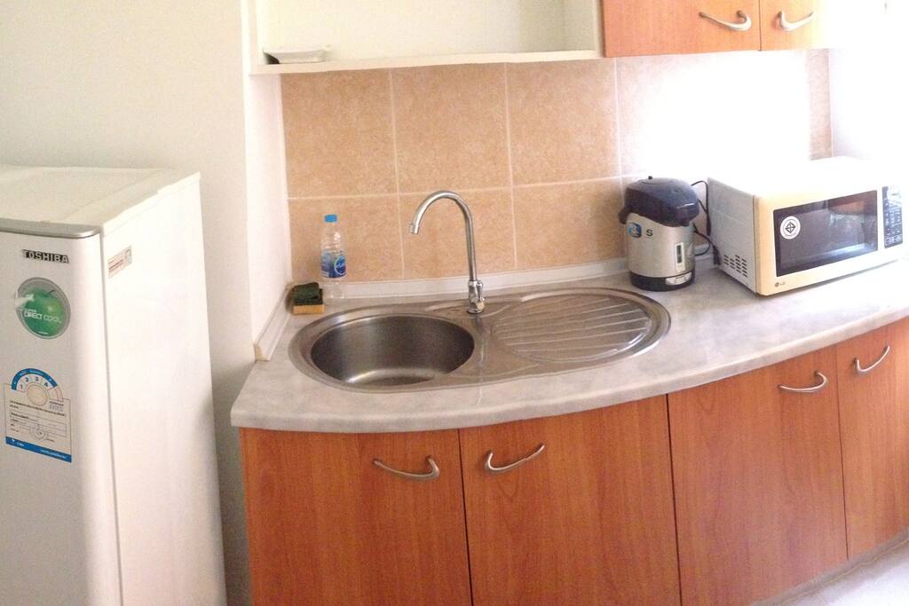 Kitchen with refrigerator and microwave